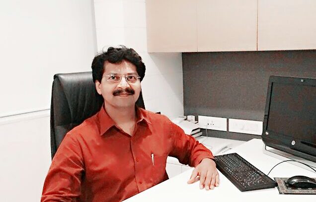Dr. Mahindra Borse, Gynaec Endoscopic Surgeon in Pune, at his clinic desk